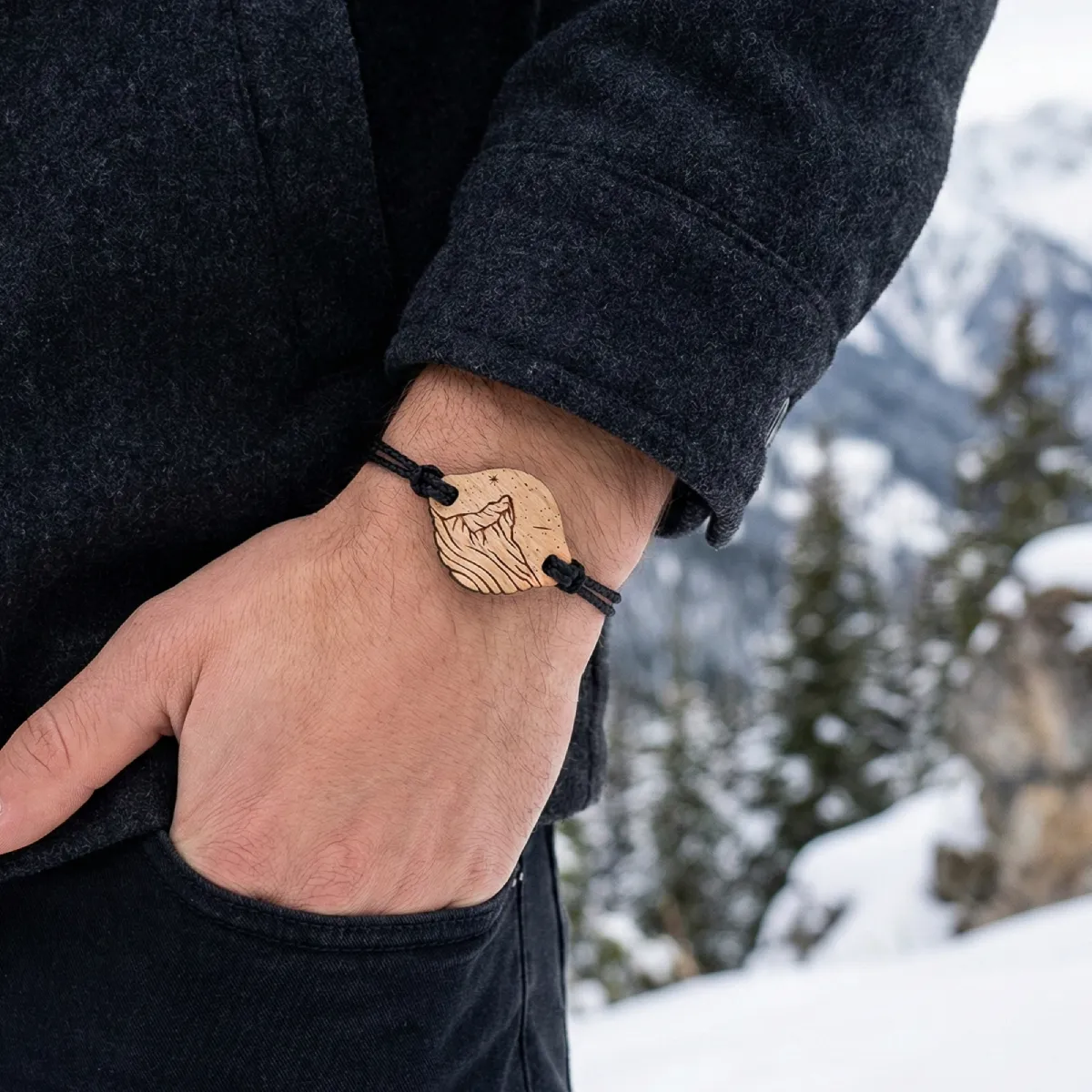 A wooden bracelet on a man's wrist in nature