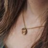 wooden necklace in the shape of the planet earth