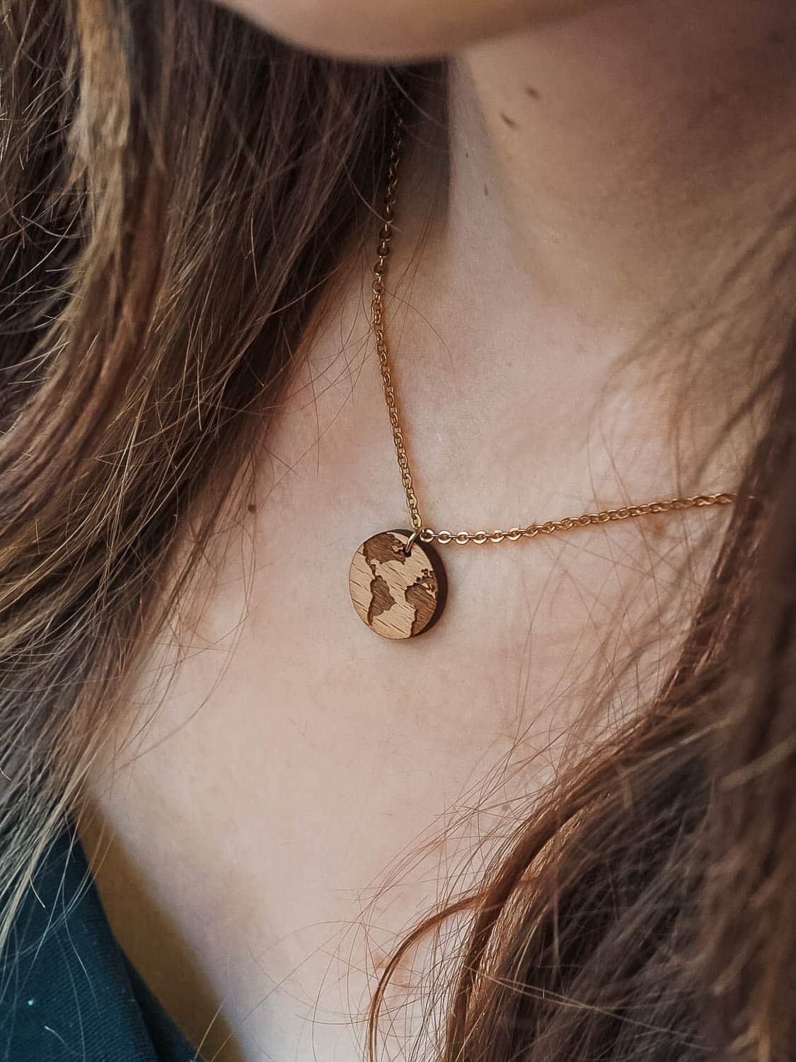 wooden necklace in the shape of the planet earth