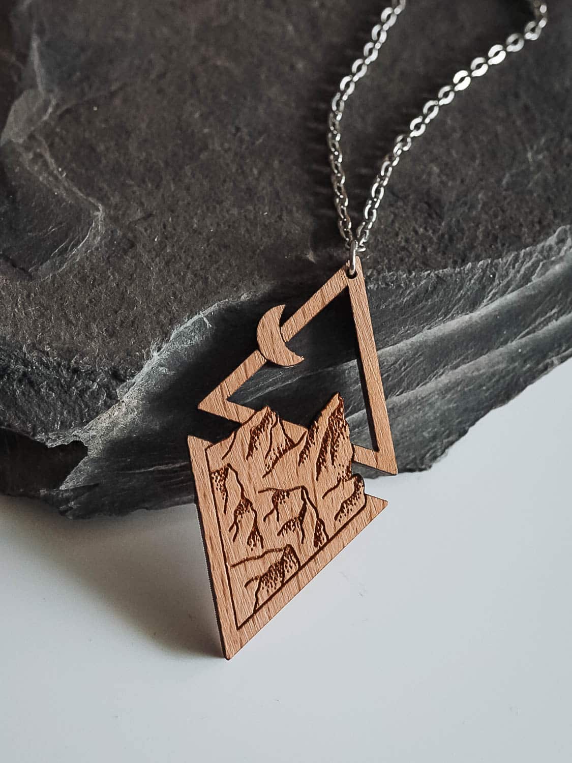 Wooden necklace with mountains, moon and sun