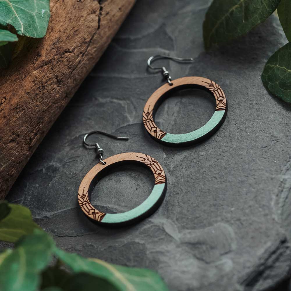 Wooden earrings with ethnic motifs painted with green acrylic