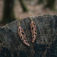 Mismatched raw Piuma feather and wood earrings