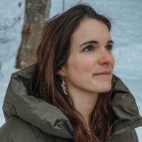 Mismatched green Piuma feather and wood earrings
