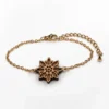 Wooden bracelet with an edelweiss design and a gold chain
